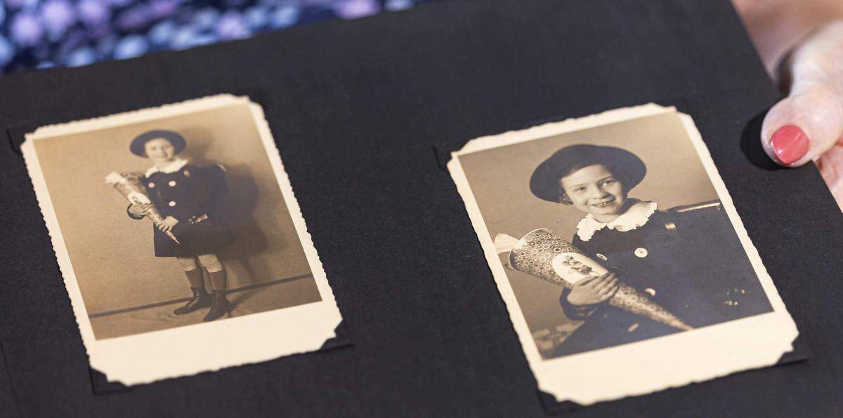 Ruth Di Stefano, de 97 años, y sobreviviente del Holocausto, sostiene un álbum de recortes con fotos de su infancia en Hamburgo. Di Stefano recibió una bolsa de regalo y una comida navideña de Goodman Jewish Family Services como anticipación de la festividad de Rosh Hashaná.