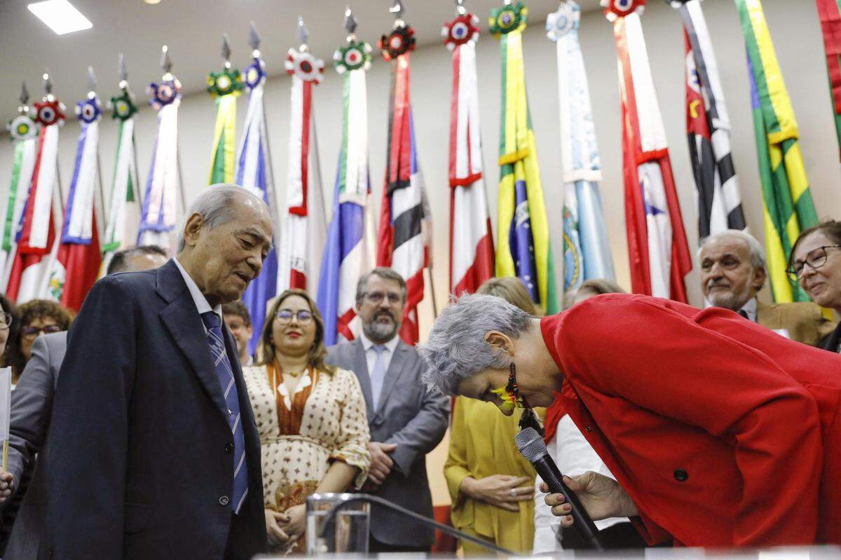 Enea de Stutz e Almeida (R), head of the Amnesty Commission of the Human Rights and Citizenship Ministry, bows and offers an apology from the Brazilian government over the persecution of Japanese immigrants during and after World War II, in Brasilia on July 25, 2024. (Photo by Kyodo News/Sipa USA)