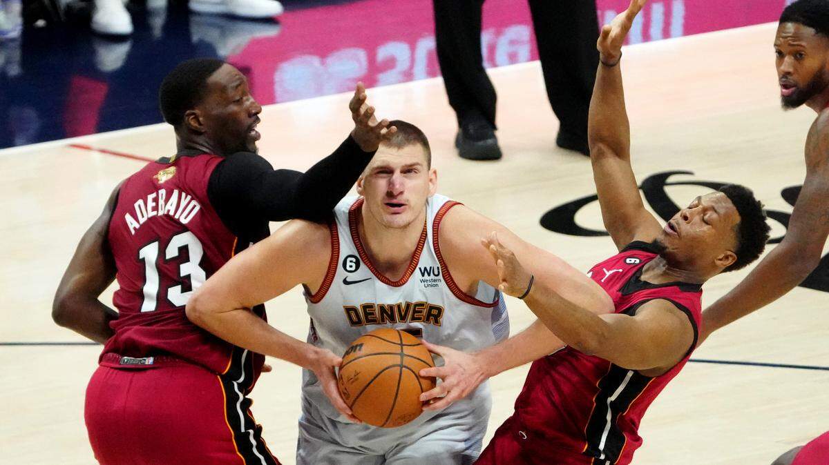 El centro de los Nugget Nikola Jokic (15) trata de entrar al aro ante la marca de Bam Adebayo (13) y Kyle Lowry, del Heat de Miami, en el quinto partido de las Finales de la NBA, celebrado el 12 de junio de 2023 en Denver.
