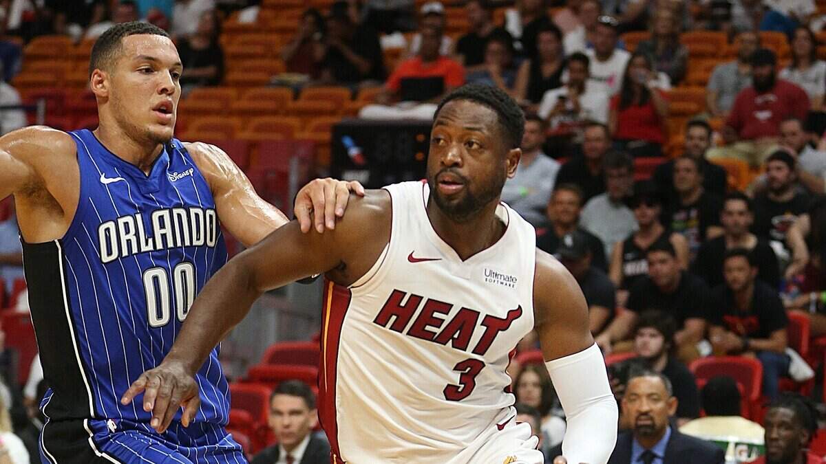 Dwyane Wade (der.) entra al aro por el Heat ante la marca de Aaron Gordon, del Magic, el 8 de octubre de 2018 en Miami.
