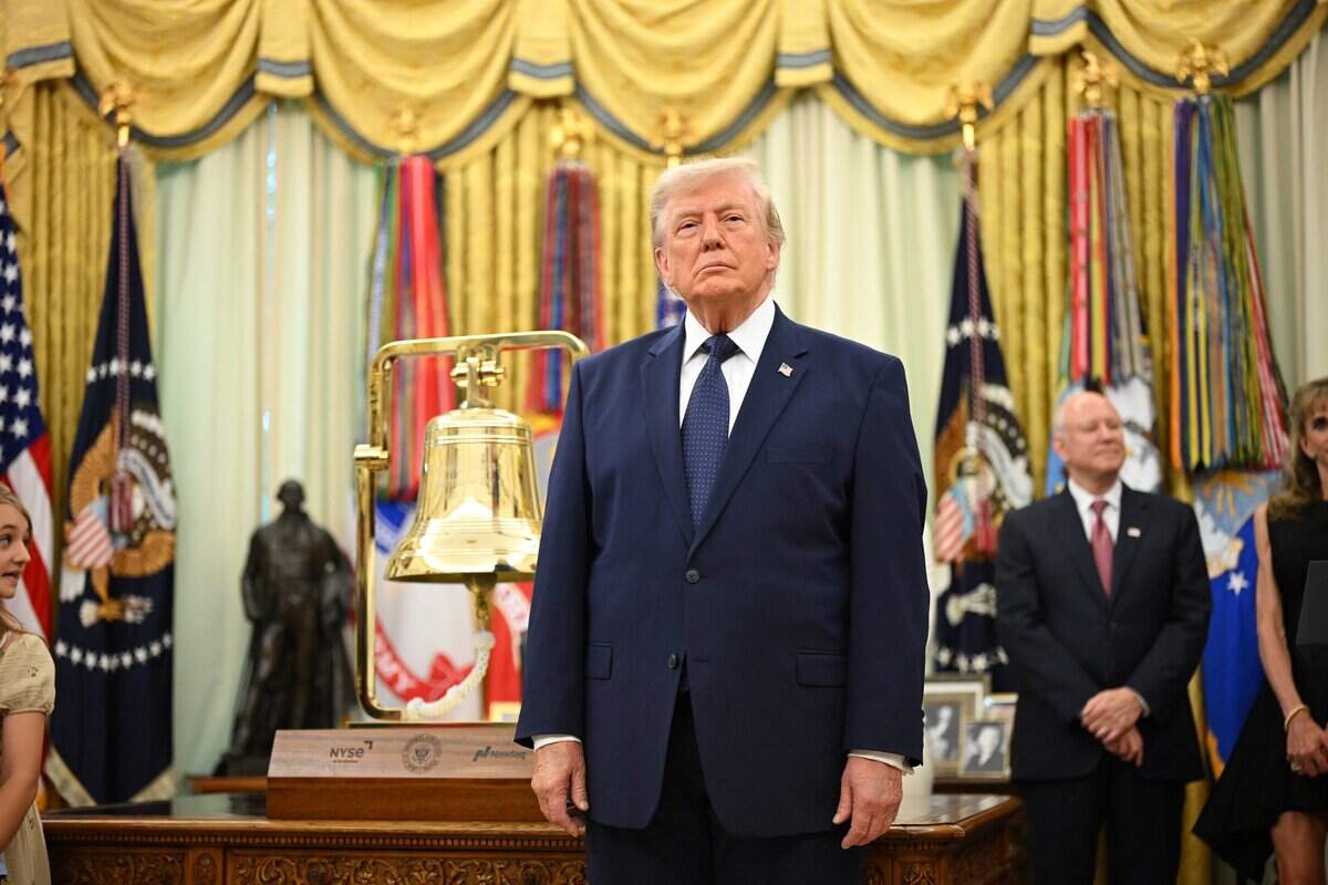 US President Donald Trump stands next to a bell before ringing it to open the New York Stock Exchange ahead of the launch of Trump investment accounts in the Oval Office of the White House in Washington, DC, on July 6, 2026. Trump accounts are a new type of tax-deferred investment accounts for children. (Photo by Mandel NGAN / AFP via Getty Images)