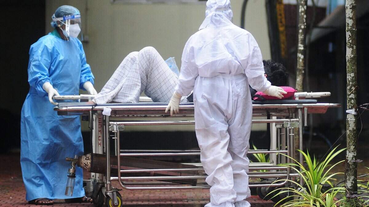 TOPSHOT - Health workers wearing protective gears shift a man with symptoms of Nipah virus to an isolation ward at a government hospital in Kozhikode in south Indian state of Kerala on September 16, 2023. (Photo by AFP) (Photo by -/AFP via Getty Images)