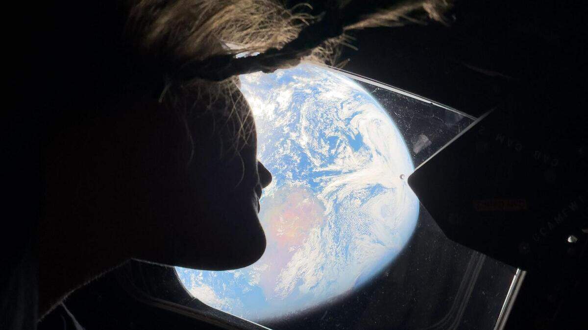 La astronauta de la NASA Christina Koch, especialista de misión de Artemis II, se asoma por una de las ventanas de la cabina principal de la nave espacial Orion el sábado 4 de abril de 2026, mirando hacia la Tierra, mientras la tripulación viaja rumbo a la Luna.
