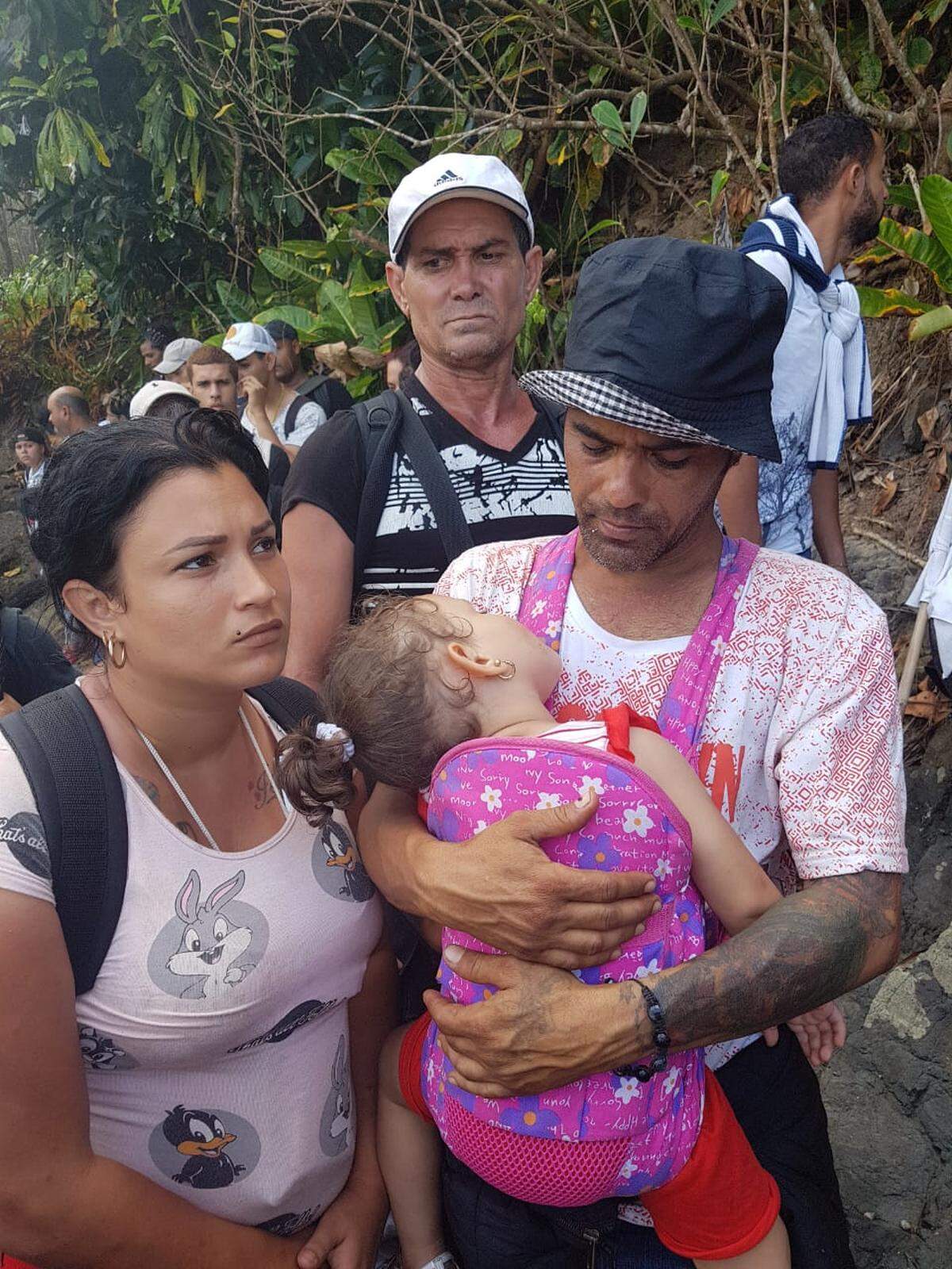 A Cuban couple carries their child through the jungle in Panama as they try to make their way to the United States.