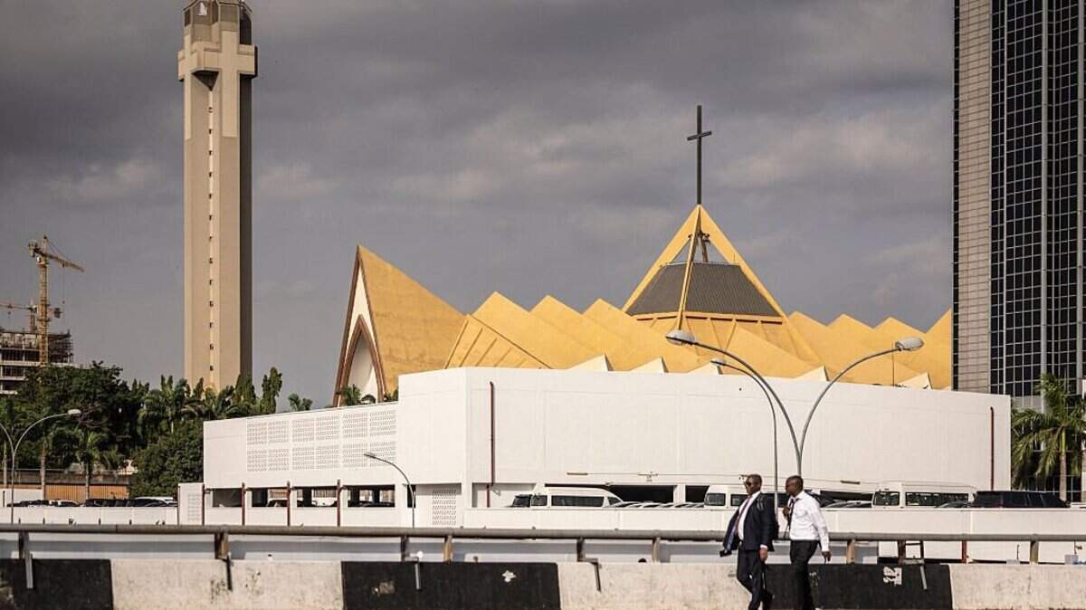 Pedestrians walk past the National Christian Church in the central business district in Abuja, on May 21, 2025. US President Donald Trump on Sunday repeated his threat of a military operation in Nigeria over killings of Christians, after the Nigerian presidency suggested a meeting to resolve the issue. Asked by an AFP reporter aboard Air Force One if he was considering US troops on the ground in Nigeria or air strikes, Trump replied: "Could be, I mean, a lot of things -- I envisage a lot of things." (Photo by OLYMPIA DE MAISMONT / AFP) (Photo by OLYMPIA DE MAISMONT/AFP via Getty Images)