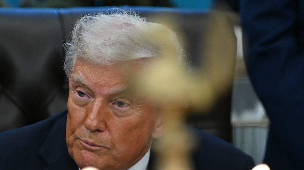 US President Donald Trump looks on as candles are lit during a Diwali celebration with American Indian leaders in the Oval Office of the White House in Washington, DC, on October 21, 2025. (Photo by ANDREW CABALLERO-REYNOLDS / AFP) (Photo by ANDREW CABALLERO-REYNOLDS/AFP via Getty Images)