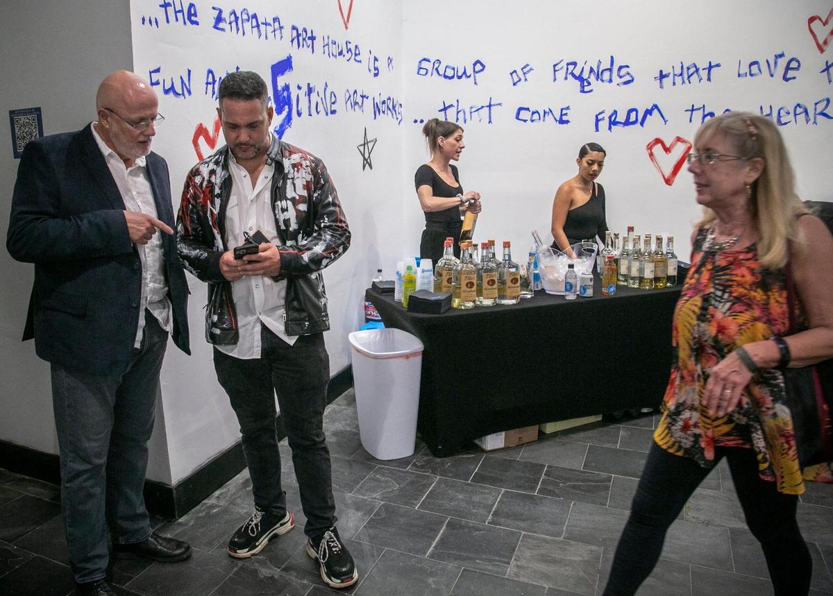 Miami Beach, Florida, December 2, 2021 - David Rosen, second from left talks to a guest during the show in Miami Beach. Spanish artists Domingo Zapata and Jacob Vilató were two of group of artists featured at a show at the David Rosen Galleries, 927 Lincoln Rd., Miami Beach.