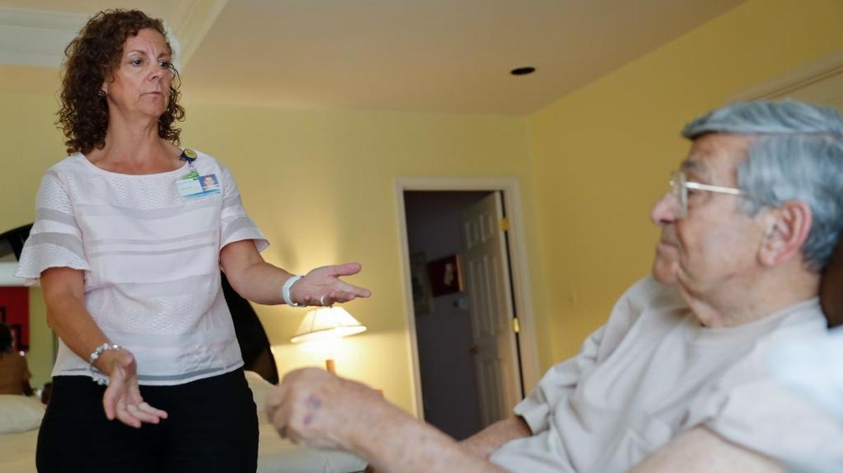 La enfremera Melissa Lantz-Garnish, de Johns Hopkins Medicine, habla con su paciente Sidney Kramer, de 92 años, para explicarle el uso del sistema de telemedicina.