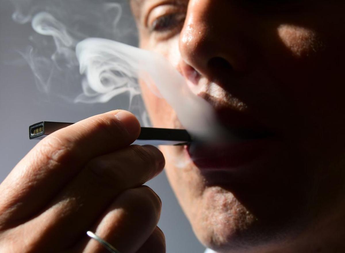 (FILES) In this file illustration taken on October 2, 2018, a man exhales smoke from an electronic cigarette in Washington, DC. (Photo by EVA HAMBACH / AFP)EVA HAMBACH/AFP/Getty Images