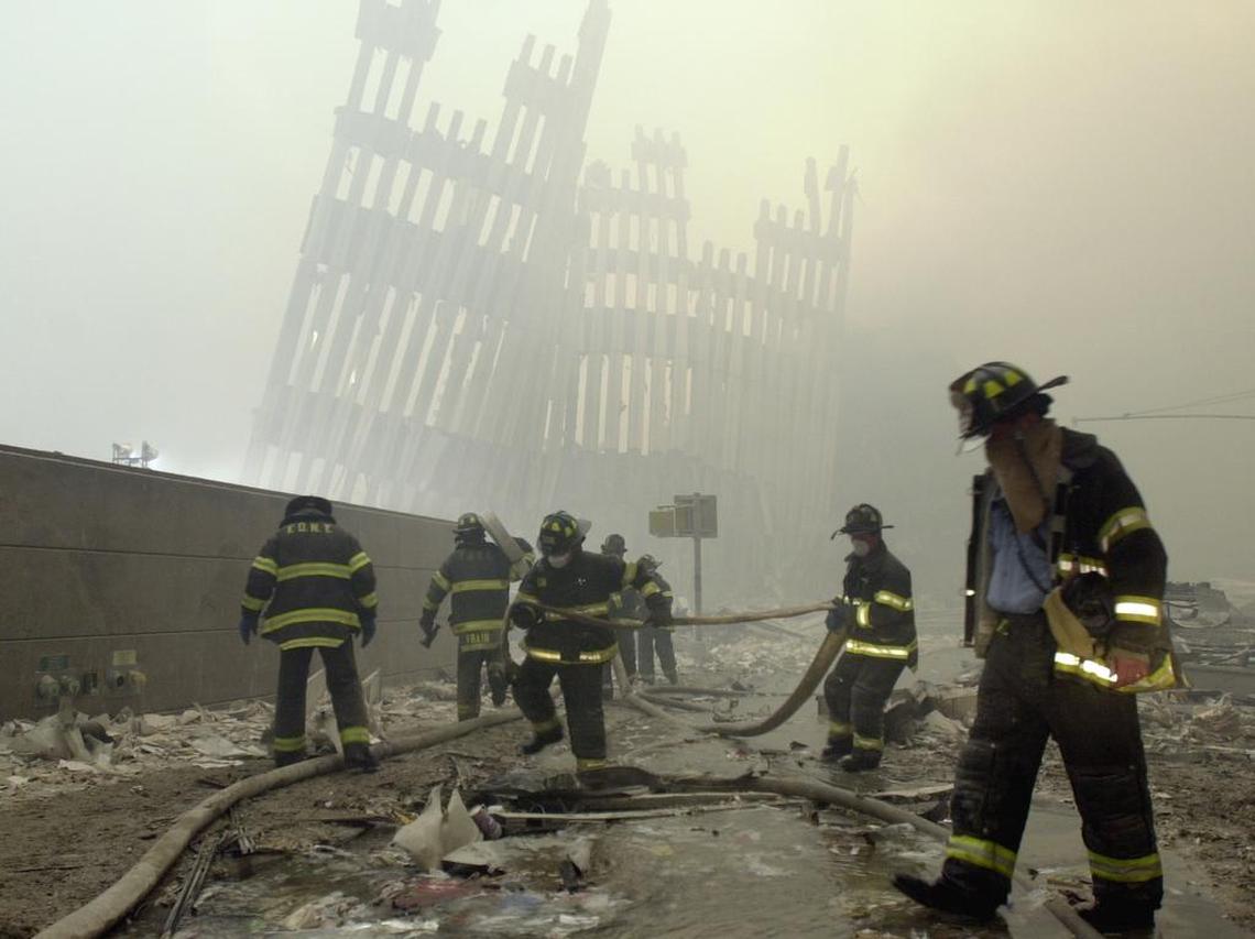 In this Sept. 11, 2001, file photo, firefighters work beneath the destroyed mullions, the vertical struts which once faced the soaring outer walls of the World Trade Center towers, in the aftermath of the Sept. 11, 2001 terrorist attacks.