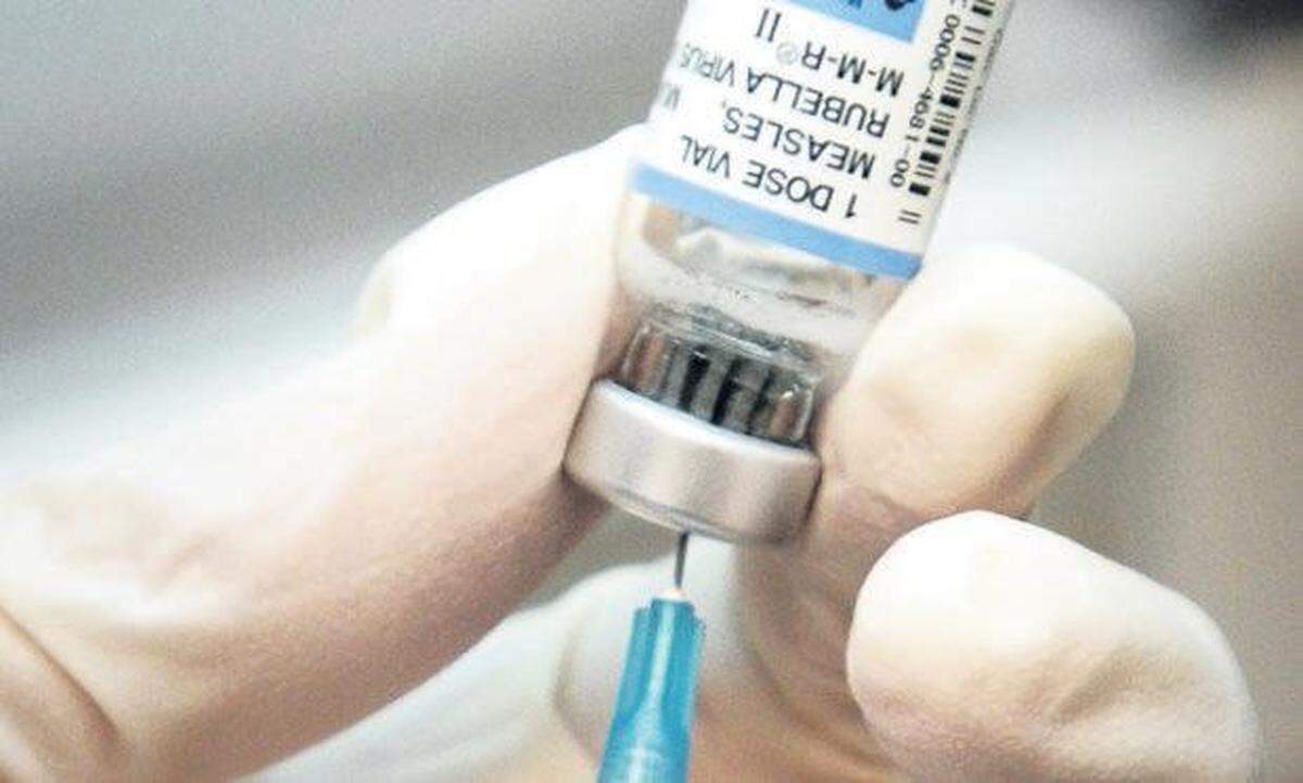 A nurse draws a dose of mumps-measles-rubella, or MMR, vaccine. A major measles outbreak in 2006 traced to Disneyland brought criticism down on the small but vocal movement among parents to opt out of vaccinations for their children.