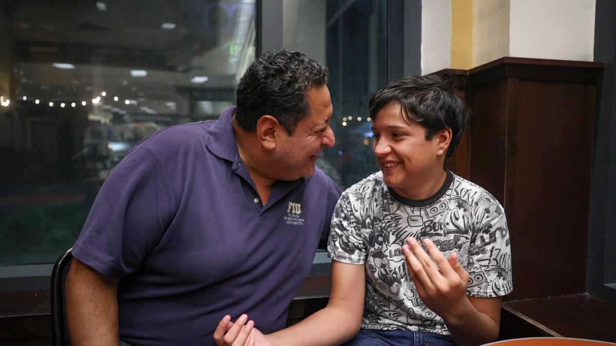 Adrian Gutierrez-Elbers, 15, right, sits with his father, Danilo, in Barnes and Noble on Monday, Dec. 6, 2022, in Pembroke Pines. He has a learning disability that affects his reading comprehension, so he is asking for a private tutor to help increase his reading level. He also enjoys researching Marie Biology and would love to get SCUBA certified so he can advance his in interest in marine life.