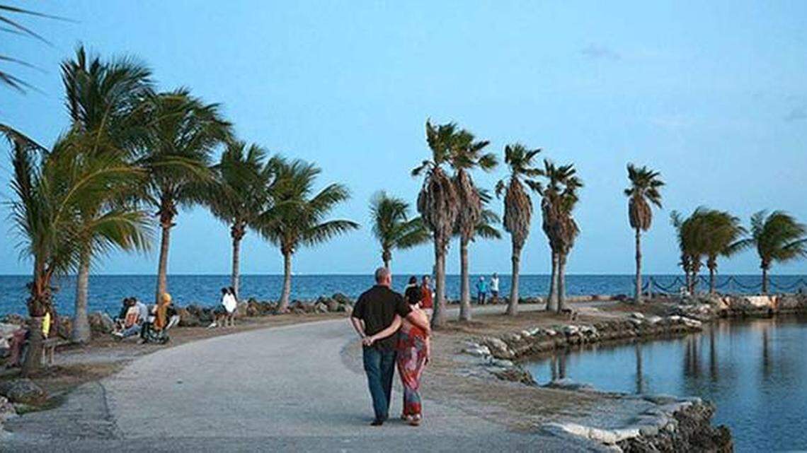 A couple walks along the atoll tidal pool at Matheson Hammock Park. A group of seven migrants from Cuba arrived at the Miami-Dade County park Monday night, Dec. 6, 2021.