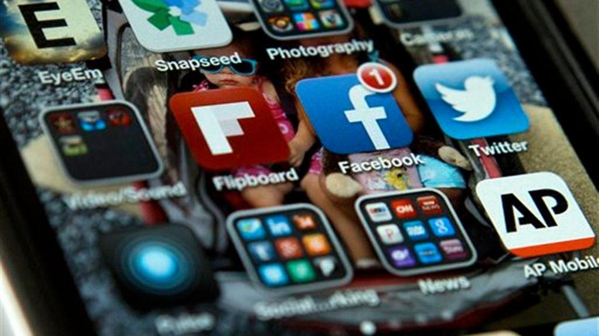 A May 21, 2013 file photo shows an iPhone with Twitter, Facebook and other social media apps used to ramp up the political toxicity.