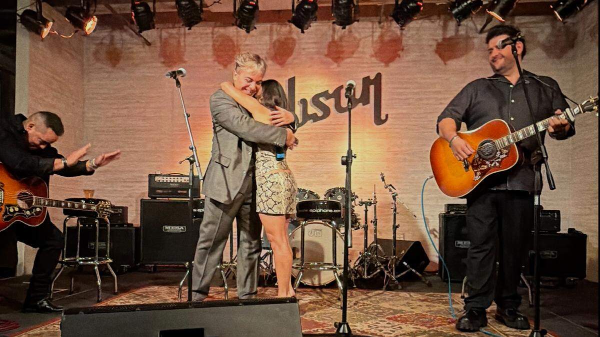 Cristian Castro y Melissa Robles se abrazan tras la presentación el 15 de octubre de 2025 en el Gibson Guitar Showroom.